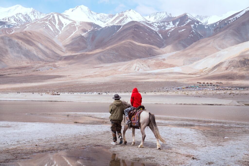 A serene horseback ride along the shores of Pangong Lake, surrounded by the majestic Himalayas.